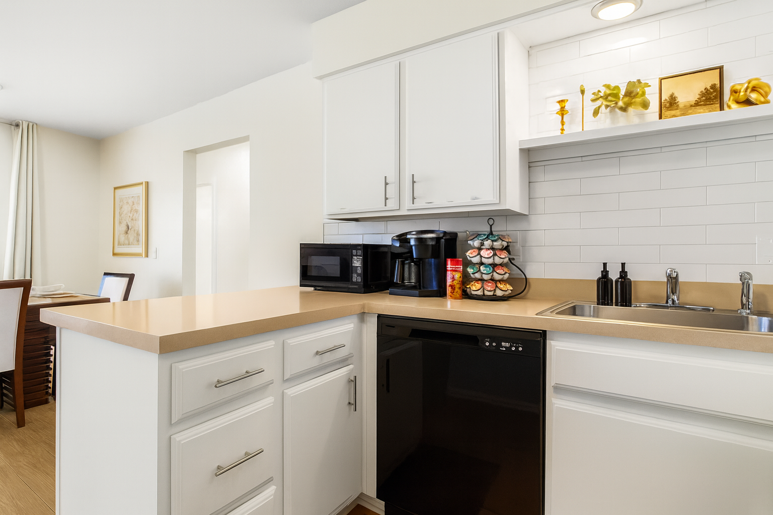 Sleek and modern kitchen with updated appliances, perfect for enjoying meals at home.
