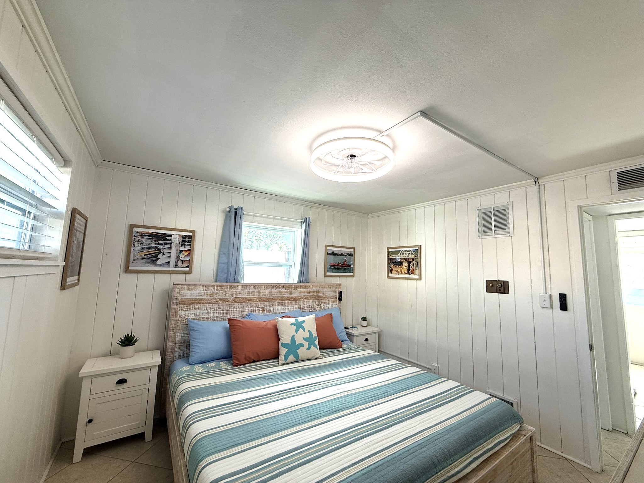 Primary Bedroom Alternate View with King Bed & Retro Photos & 65" TV