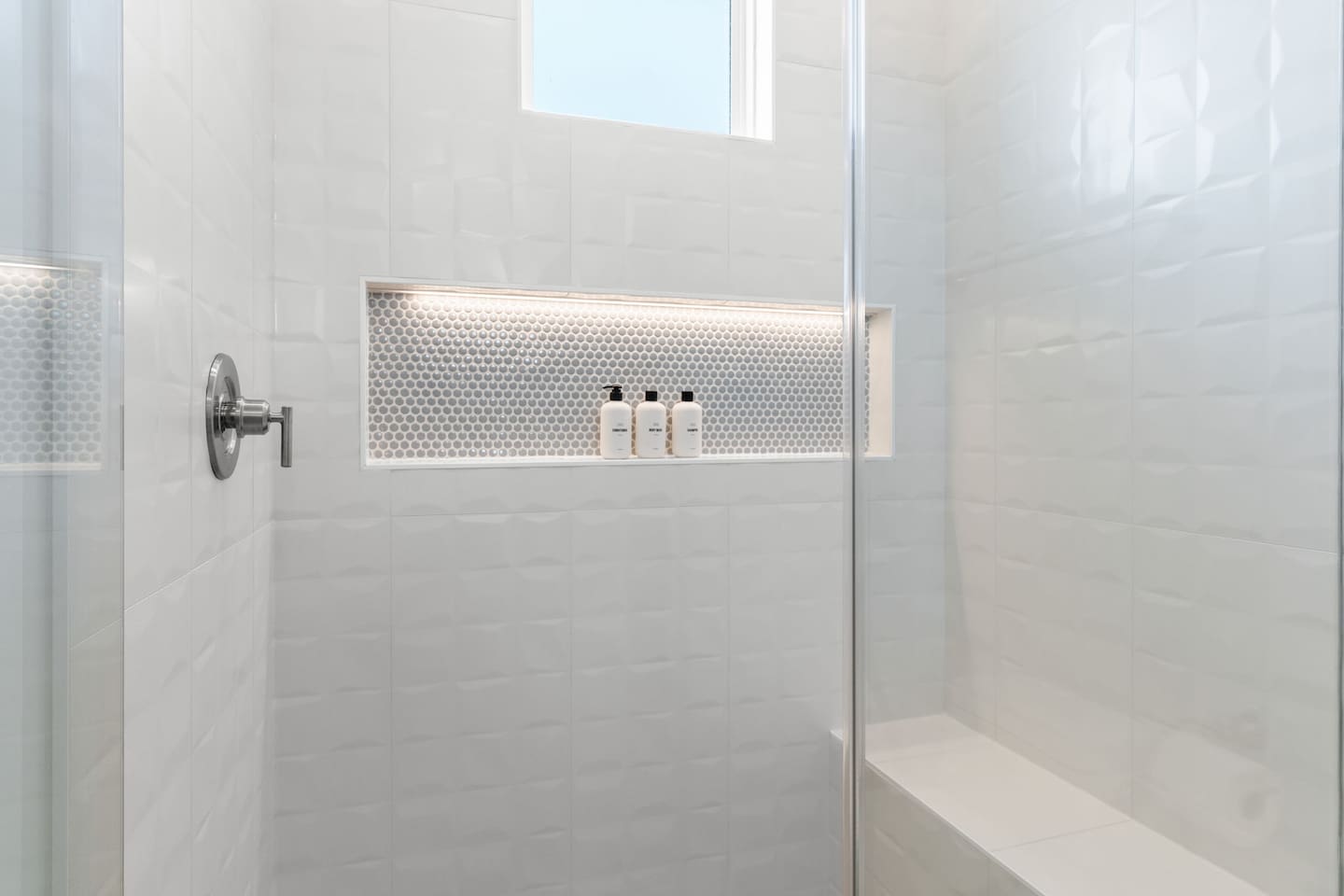 Thoughtfully designed for every guest, each bathroom features spacious curbless showers with built-in benches, blending accessibility with modern comfort and style.