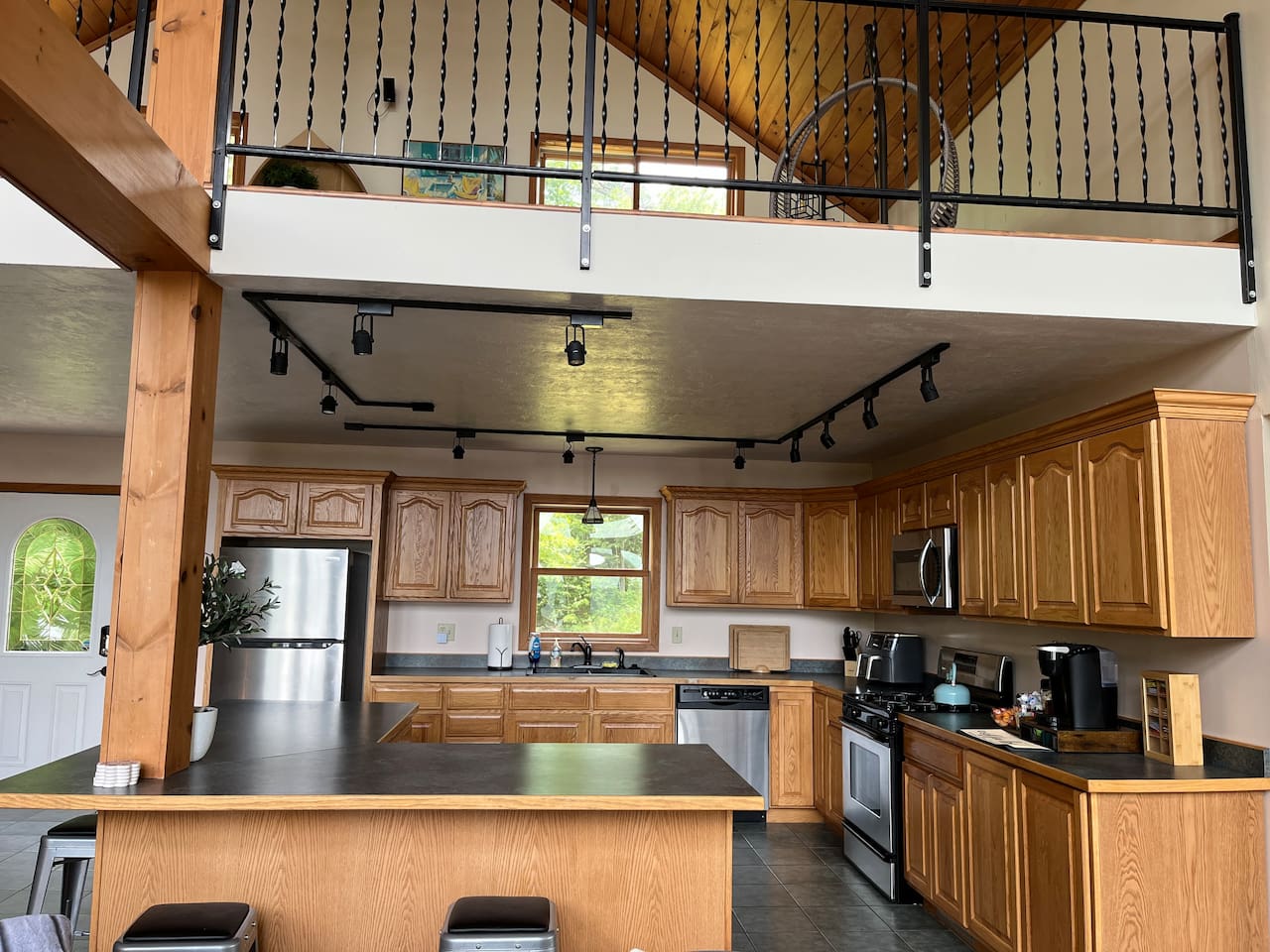 Spacious kitchen with coffee bar, basic spices and necessities for cooking and eating.  Four stools align the counter. Opens into living room so never away from the action or view. 