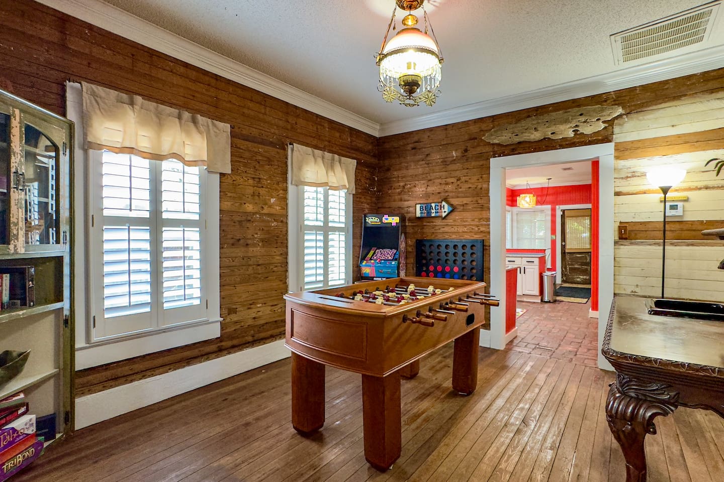 Character-filled game room featuring foosball, classic games, and a warm, vintage vibe.