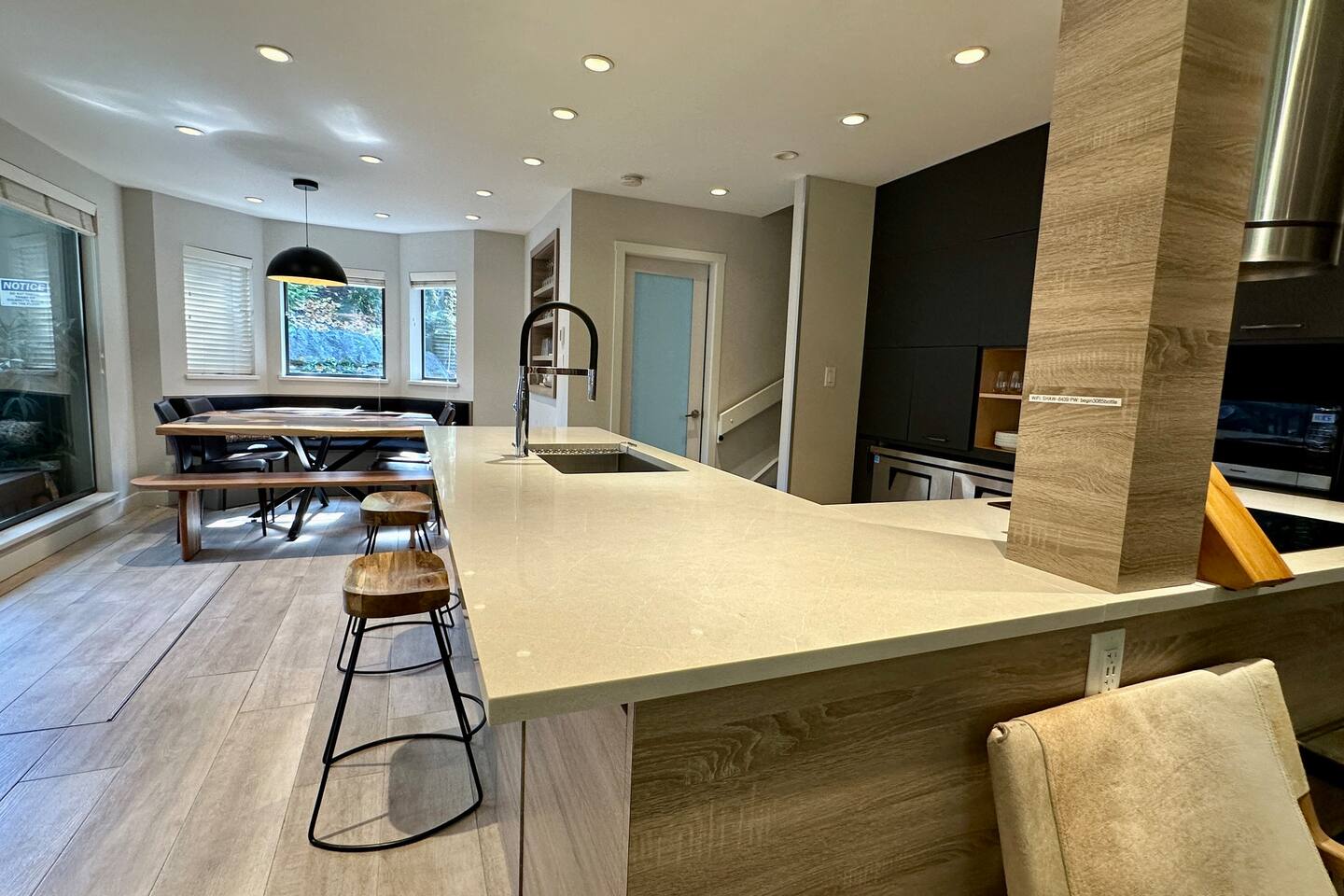 Large center island is the heart of this modern kitchen, featuring built in commercial fridge and freezer.  The space transitions effortlessly from food prep to entertainment hub.  