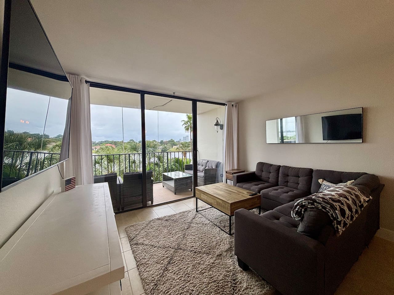 A large TV and comfortable couch is yours to enjoy throughout your stay.