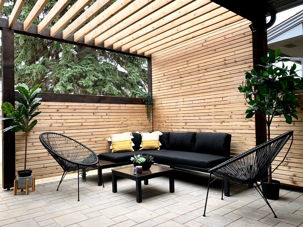 Private side patio with seating — designed for guest use in warmer months.