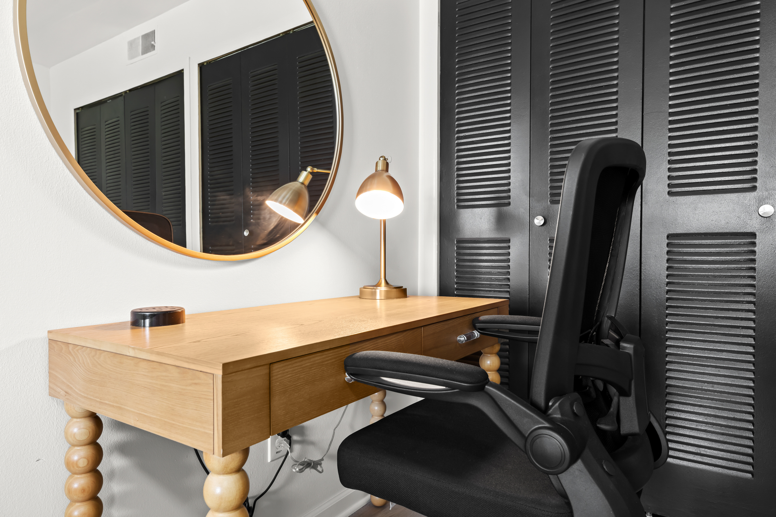Comfortable workstation with desk, chair, and good lighting for remote work.
