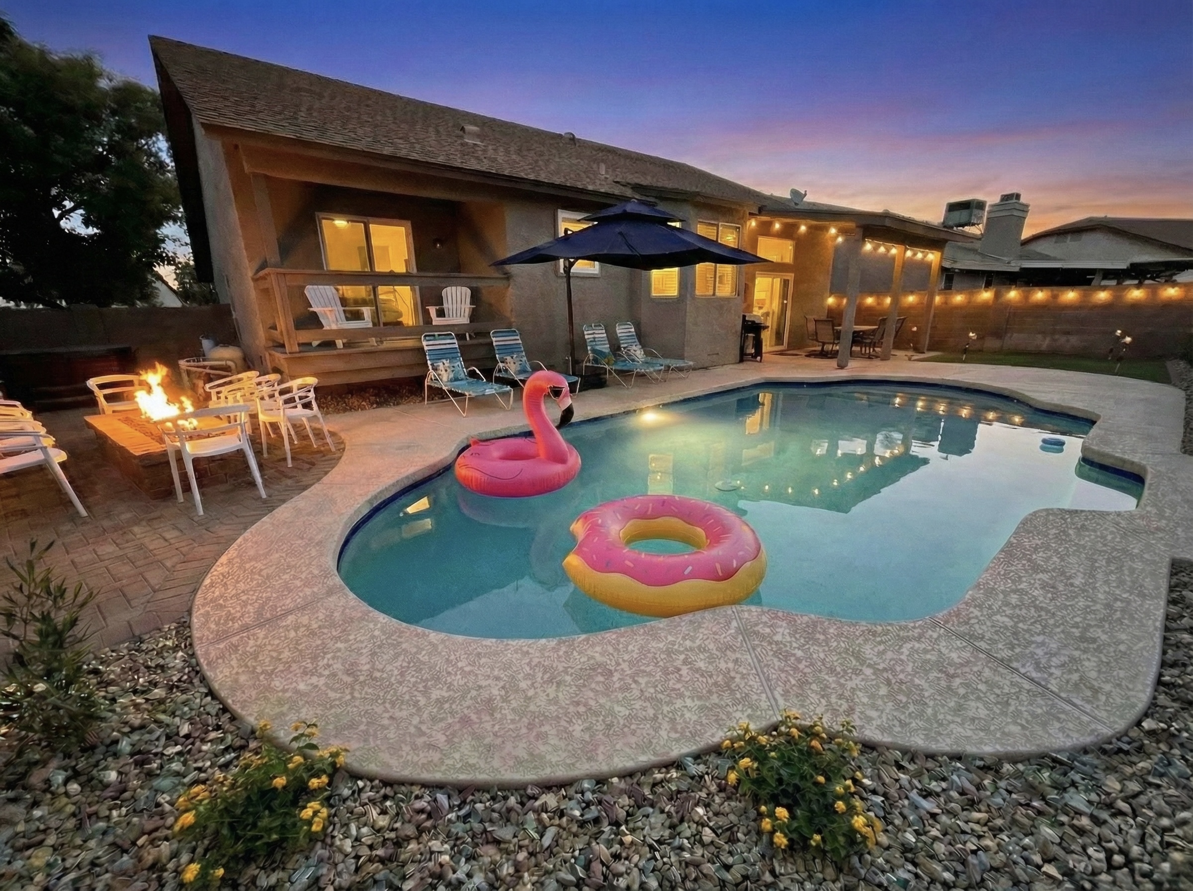 Backyard has a swimming pool (can be heated for additional fee), gas fire pit, hot tub, putting green, sun loungers, dining table for 8, and gas grill.