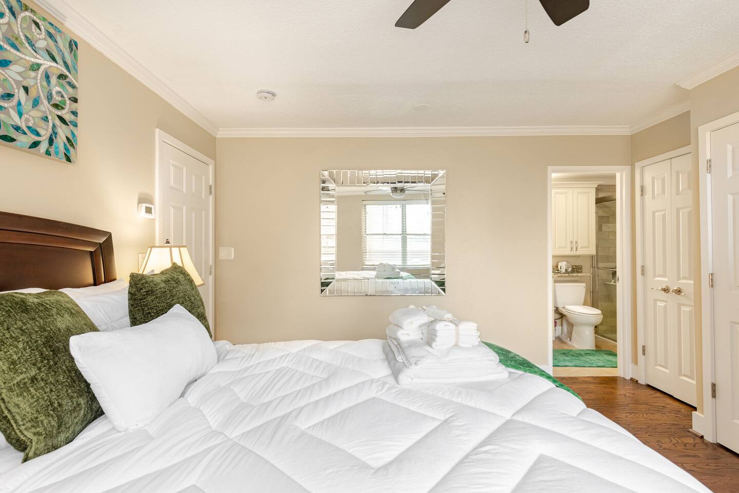 Comfortable guest room w/ large window & cozy bedding.