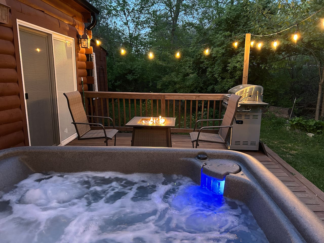 Fire table and propane grill by hot tub.
