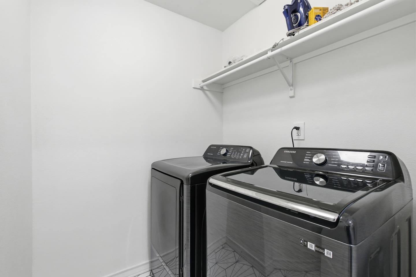 Private laundry room with modern washer and dryer for guest convenience.