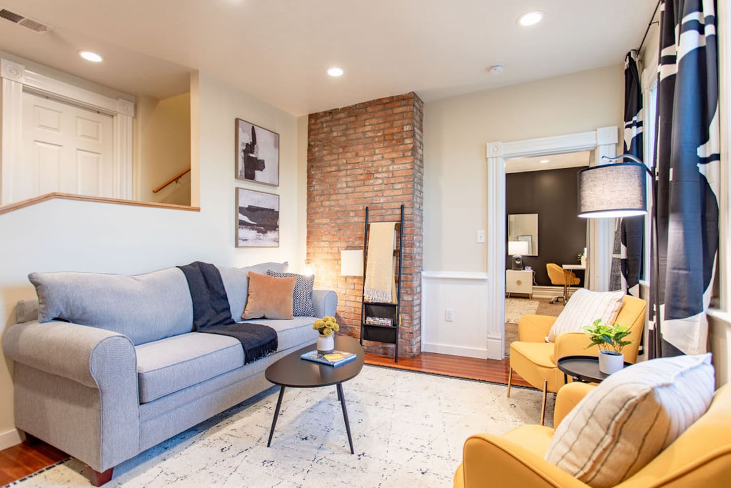 Living area featuring a comfortable couch, a stylish center table, and tasteful wall décor, creating a cozy and aesthetically pleasing space to relax and unwind.