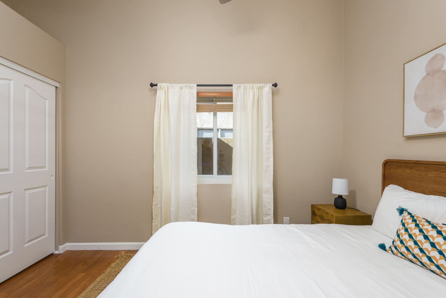 Guest Bedroom 2 with a queen bed, ceiling fan, bedside tables, and a calm setup for a comfortable stay.