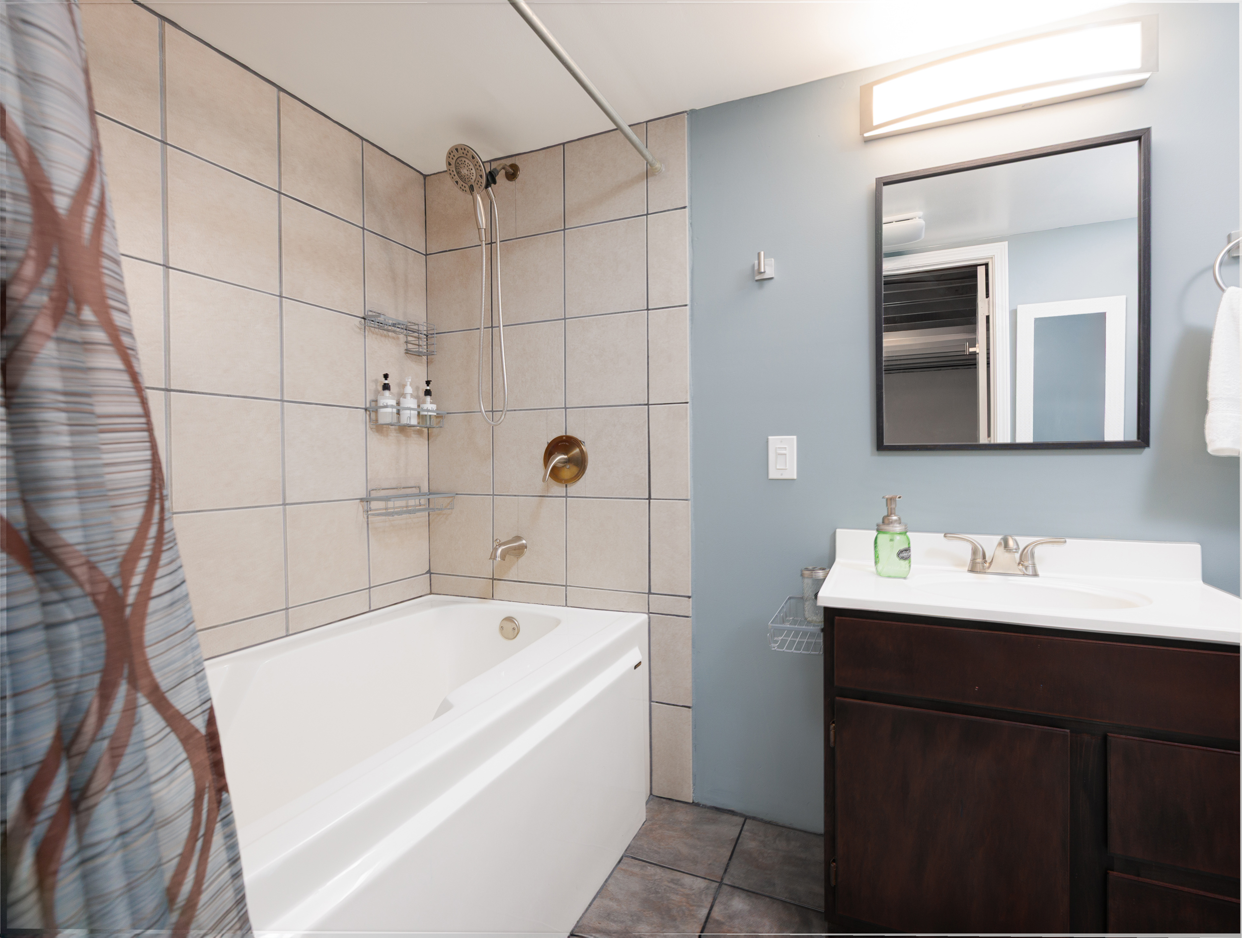 Basement bathroom with a six-foot tub and shower combination for added comfort.
