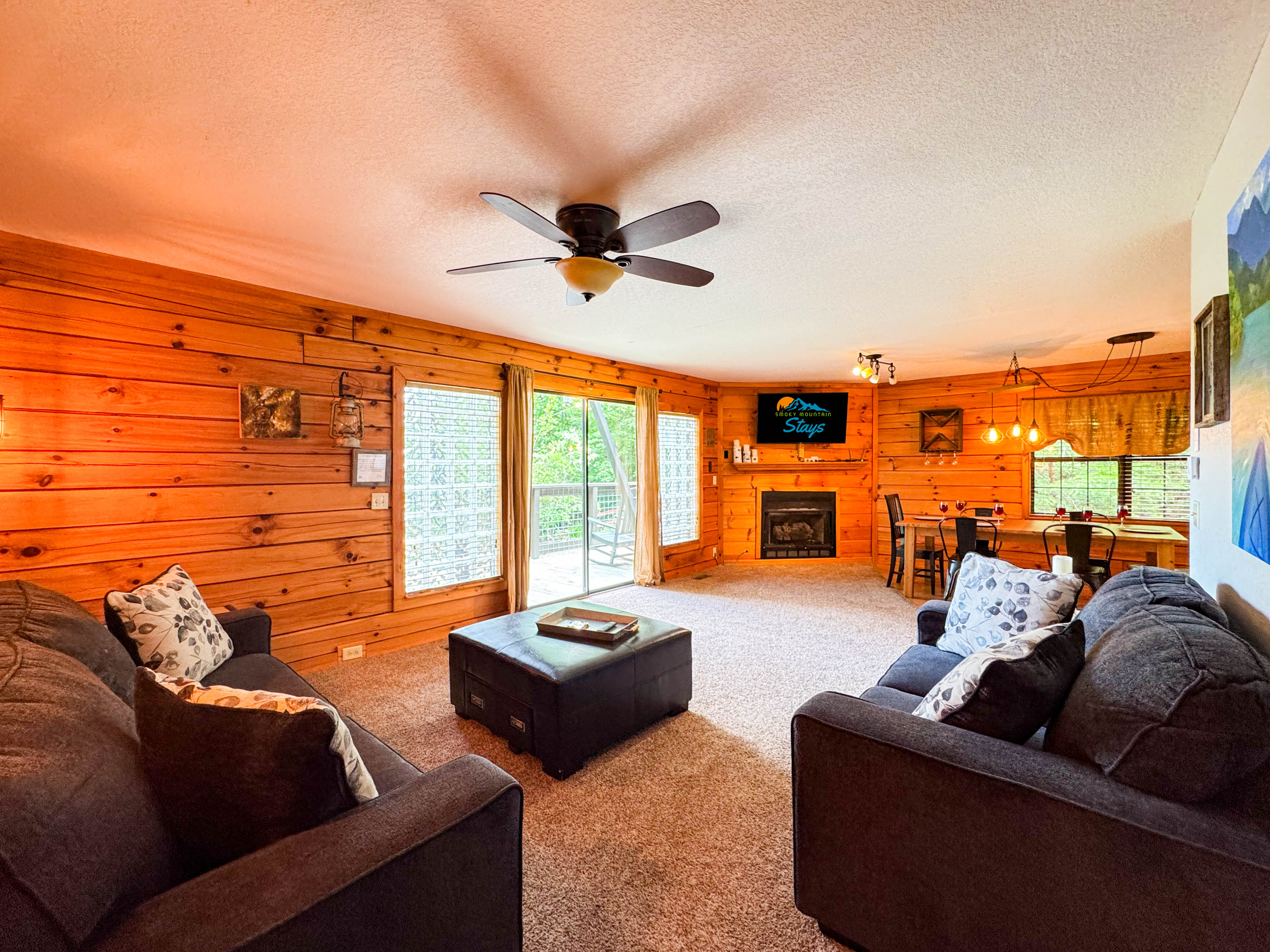 Main level living room featuring an open space, comfy seating, and a 55" Smart TV.