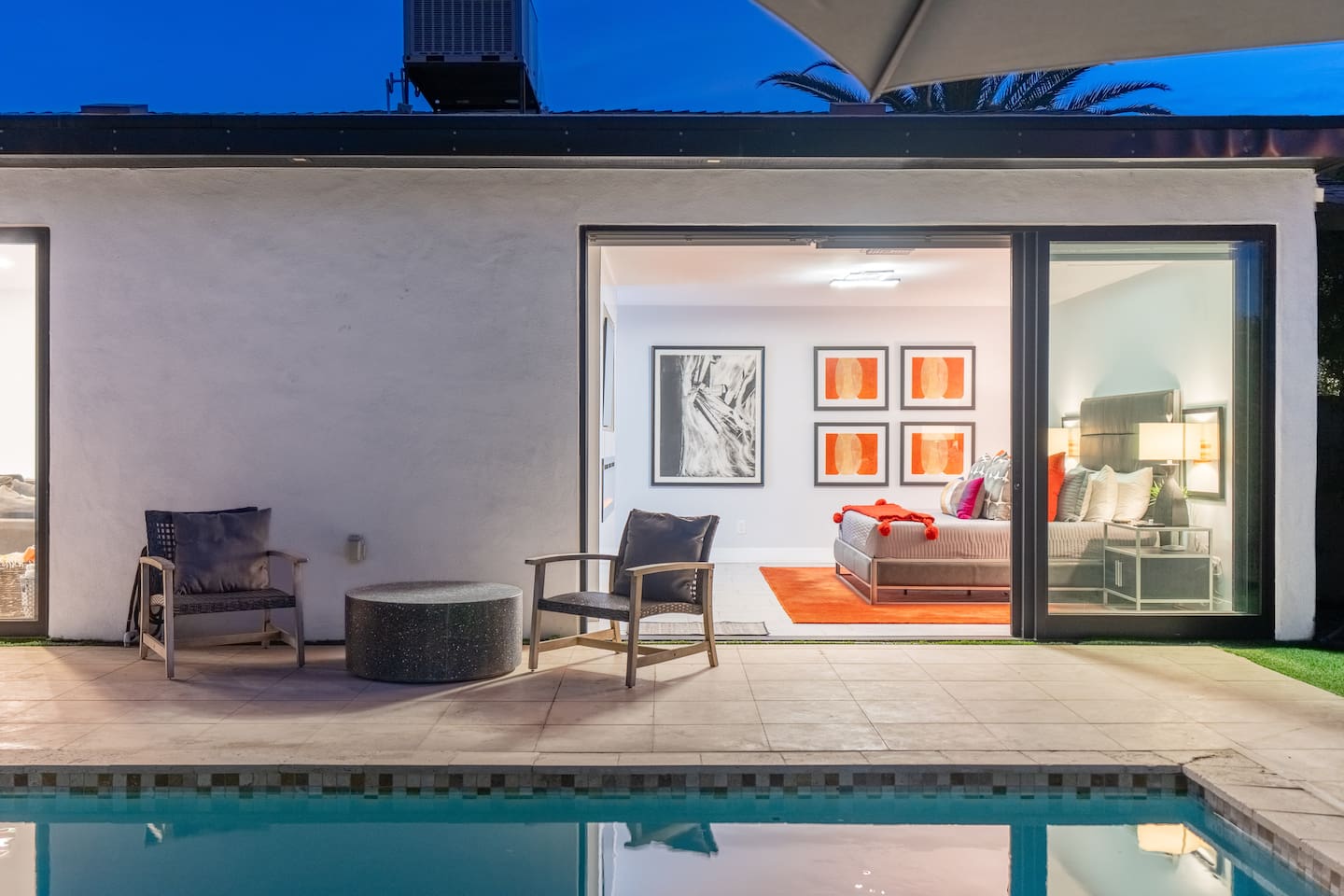 Relax just steps from the pool in this cozy seating nook outside the vibrant bedroom suite.