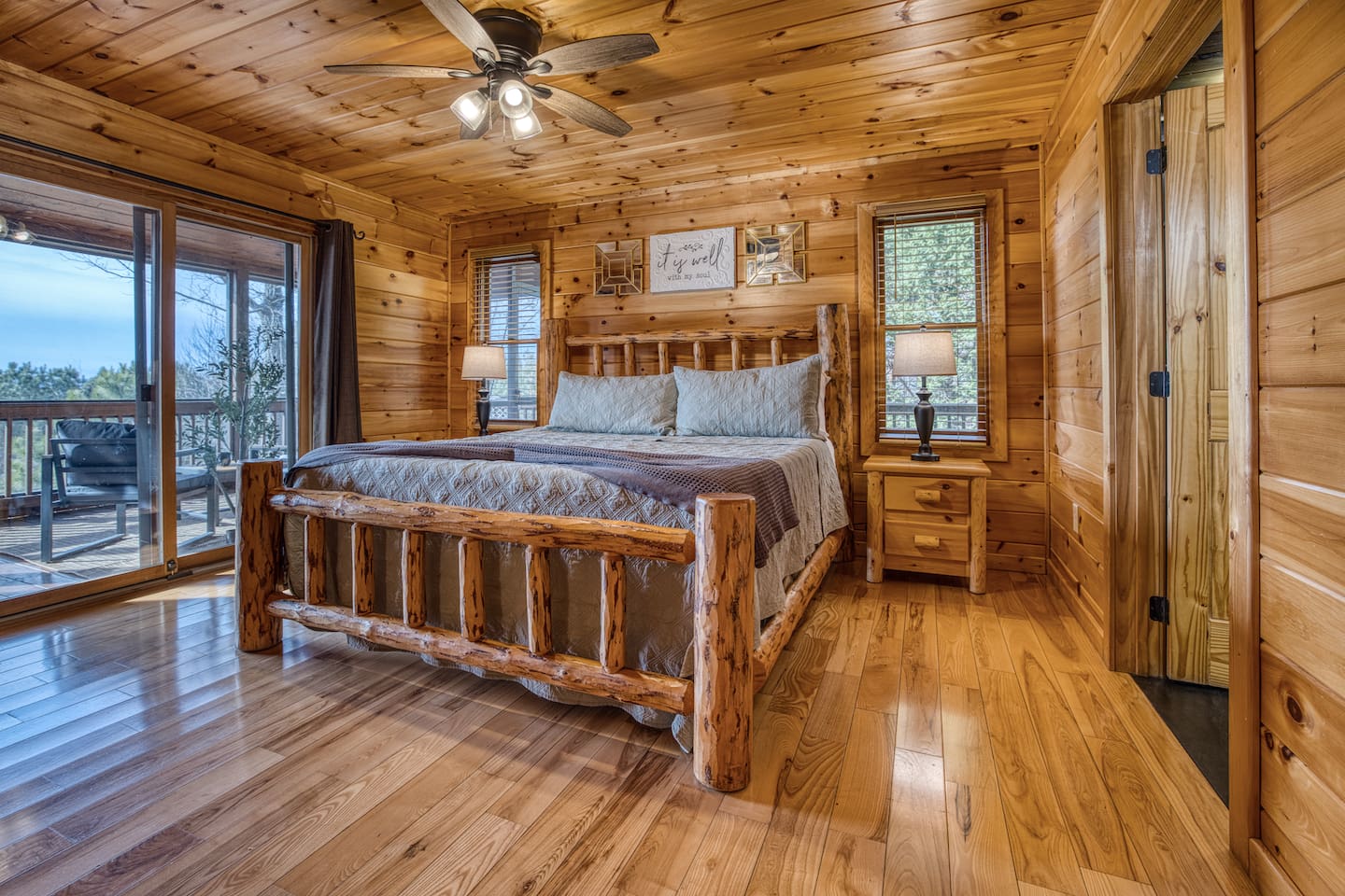 Main-level master bedroom includes a king bed, a private full bathroom, and mountain views! The screened-in patio is right off the master bedroom. 