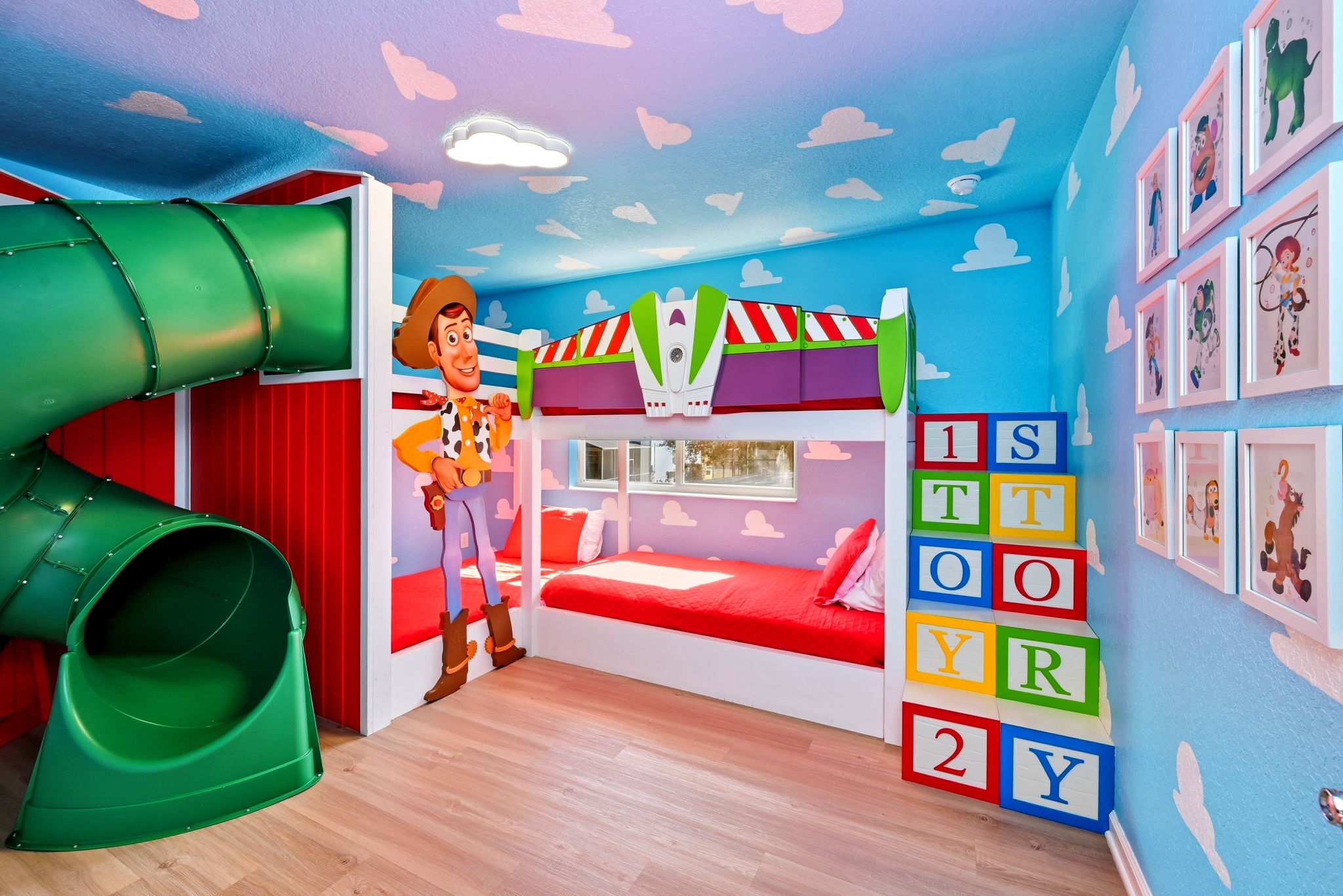 Four twin beds and a TUBE SLIDE in our custom made Toy Story bedroom
