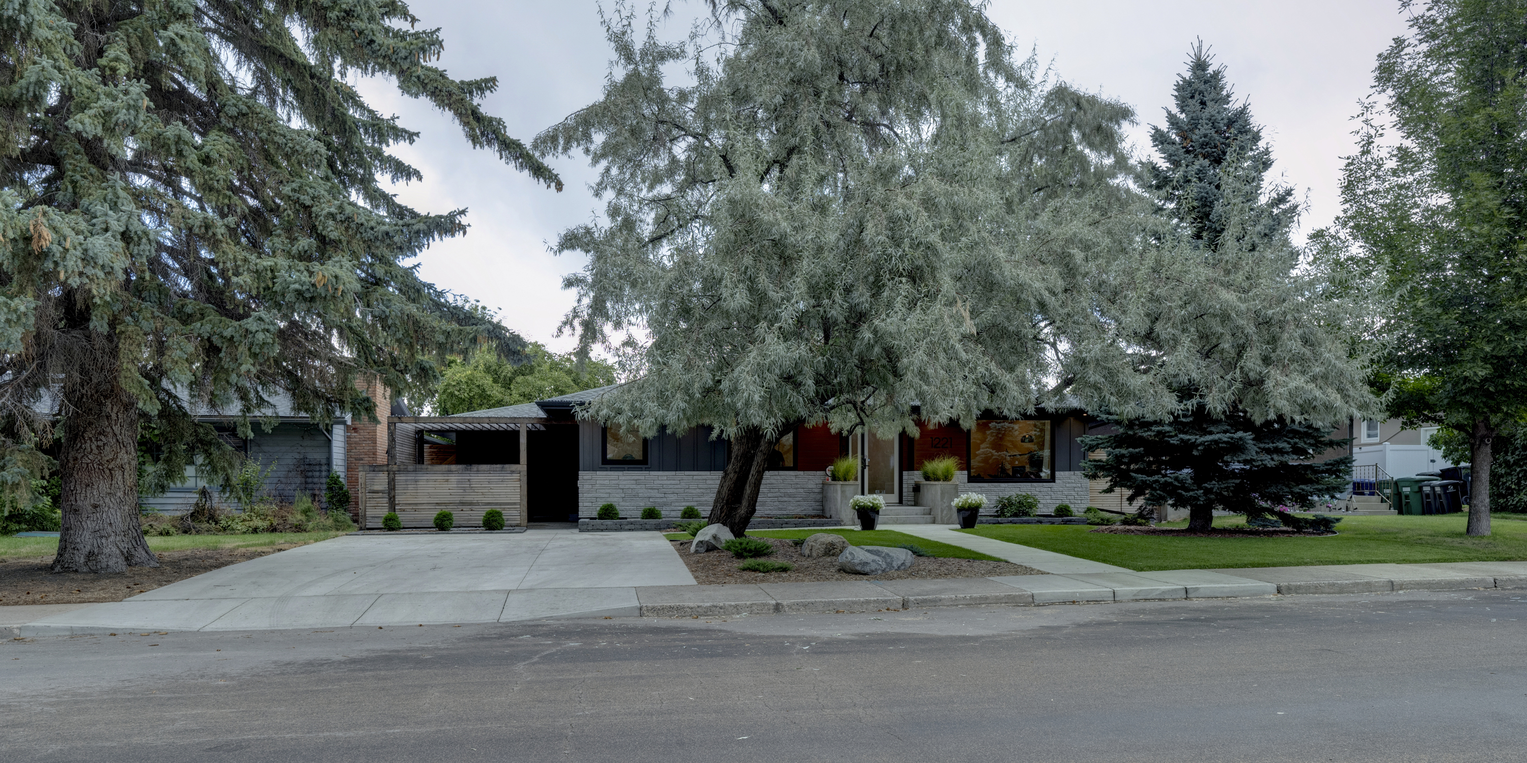 Street-level view of the home within one of Saskatoon’s established residential neighbourhoods.
