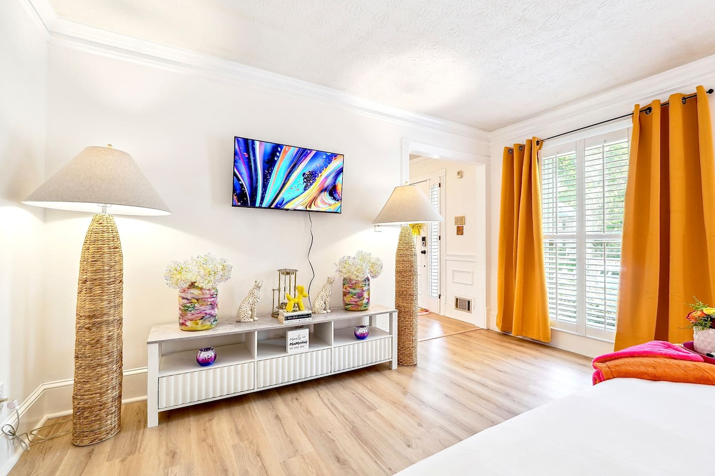 Bedroom 1 is located on the main level and features a king-size bed, TV, and a no ensuite bathroom. A nearby half bathroom is available for guest use.