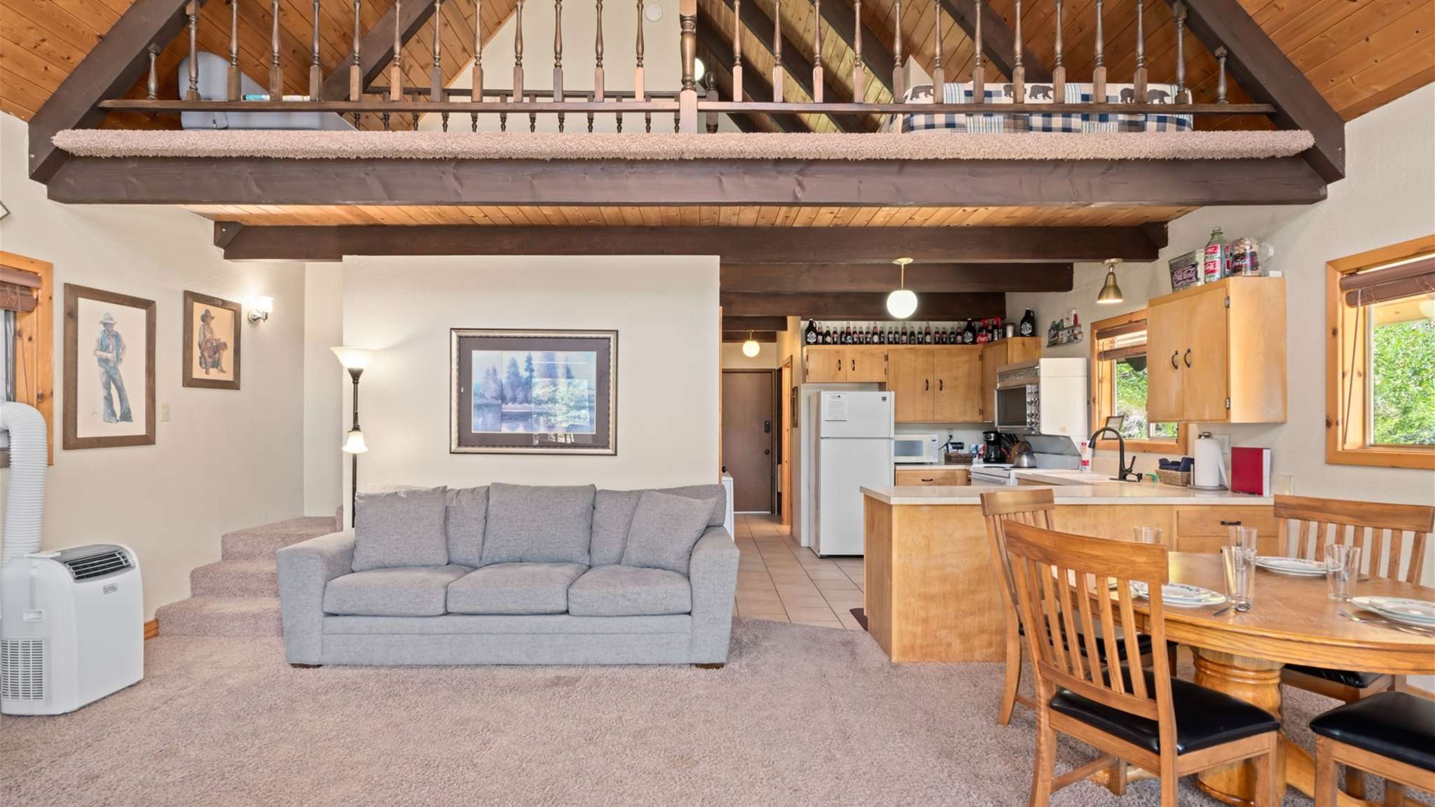 Warm cabin interiors with vaulted ceilings and cozy mountain charm.