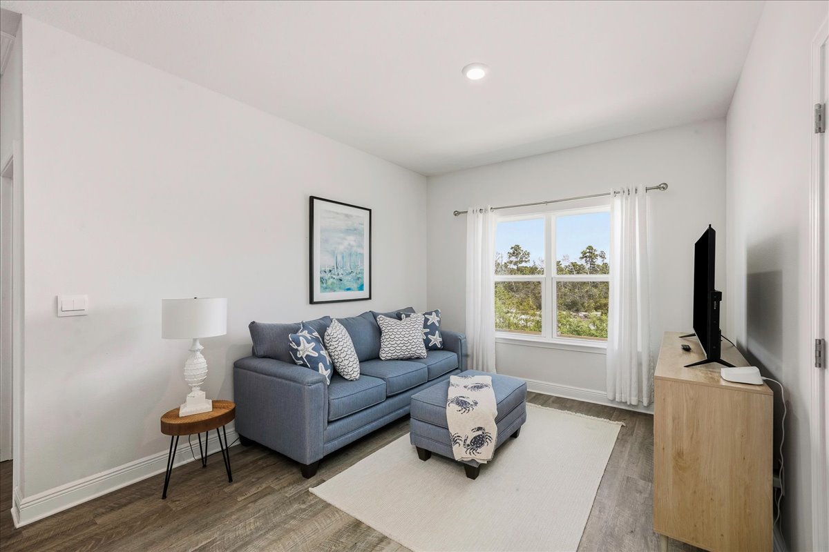bright and airy second living room upstairs featuring a Smart TV, warm lighting, and a cozy lamp, perfect for relaxing or movie nights.