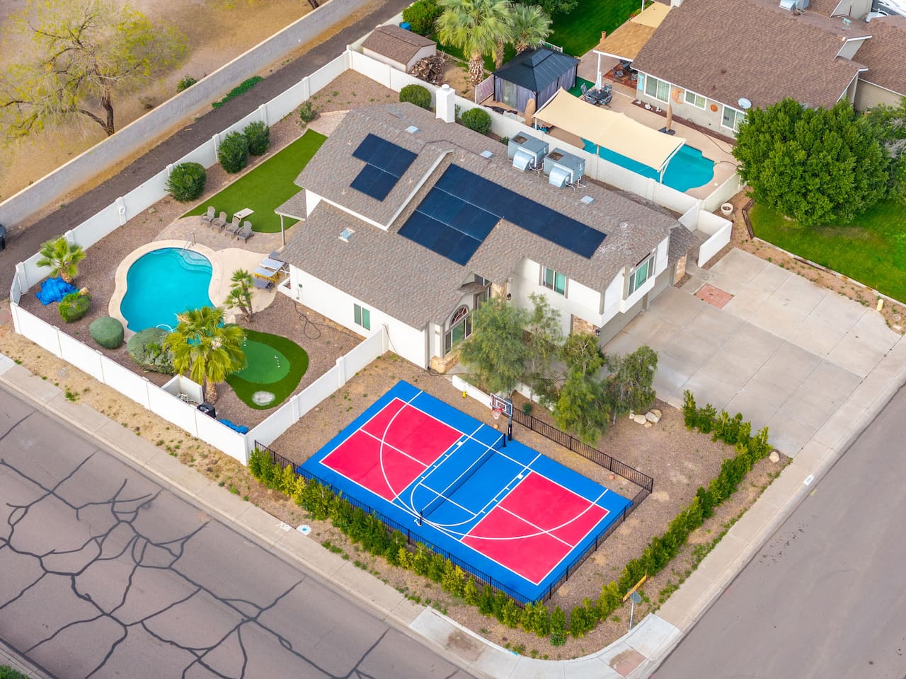 A backyard built for play — pool, court, and green all in one stunning layout.