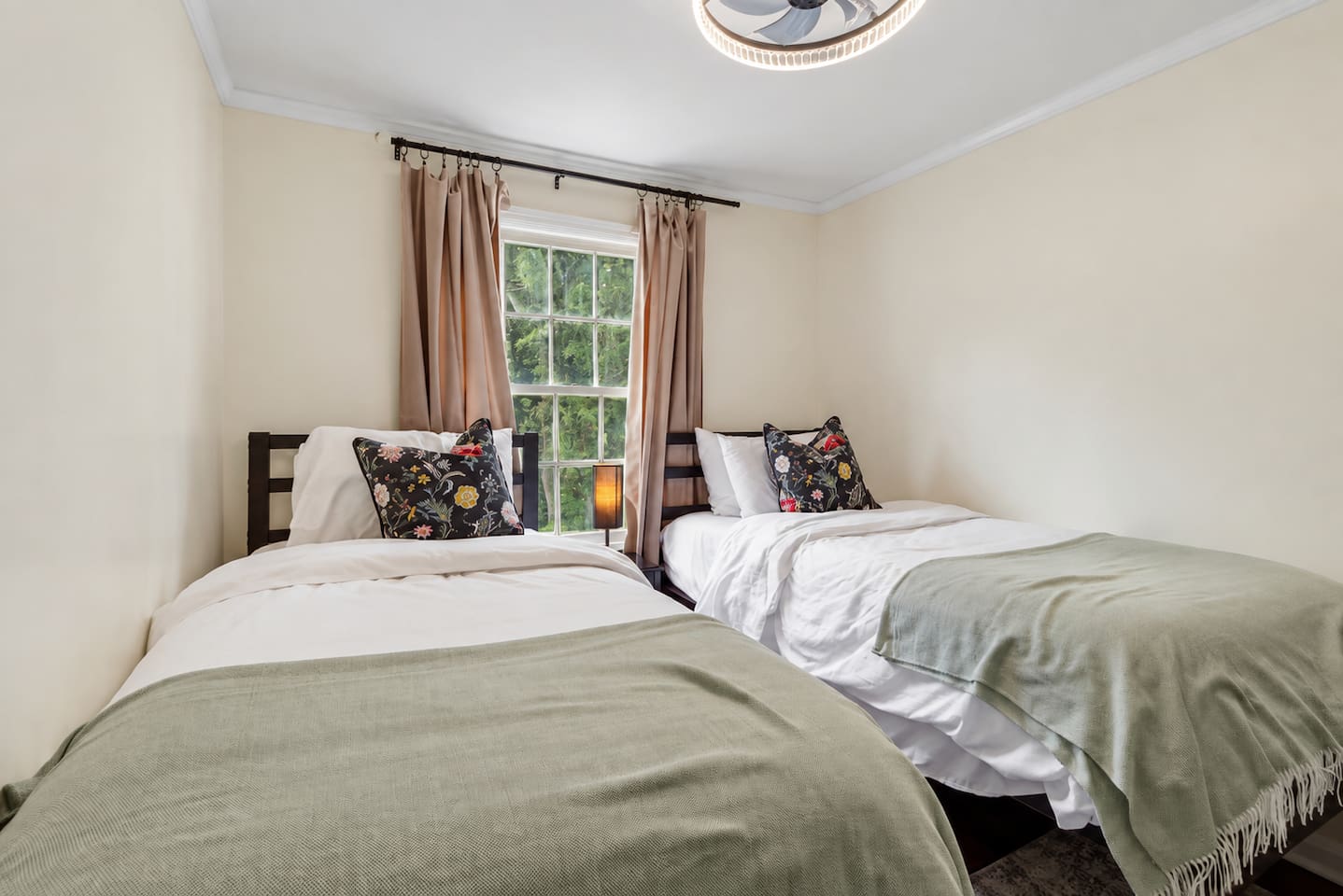 Cozy bedroom three, with two twin beds, a dresser, and a smart TV for added comfort.