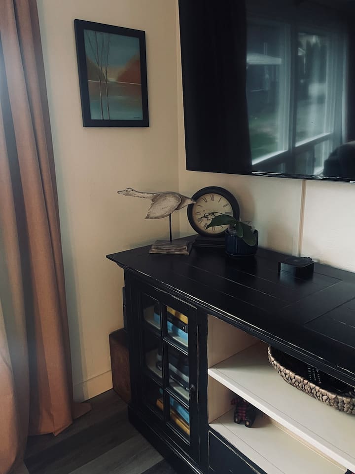 A curated collection of books fills the shelves, inviting quiet exploration and adding depth and character to the living space.