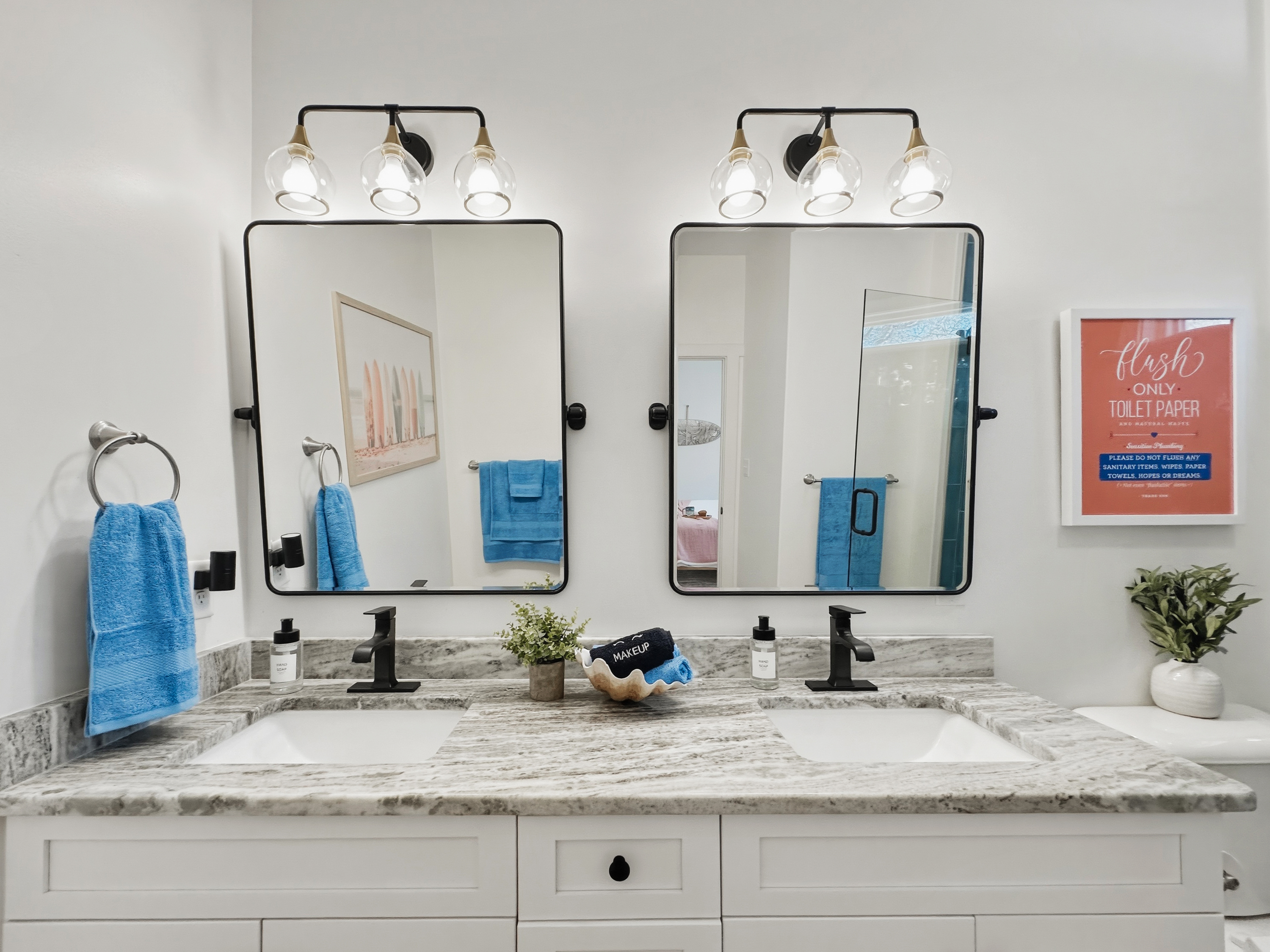 The en-suite bathroom has a bright double vanity.