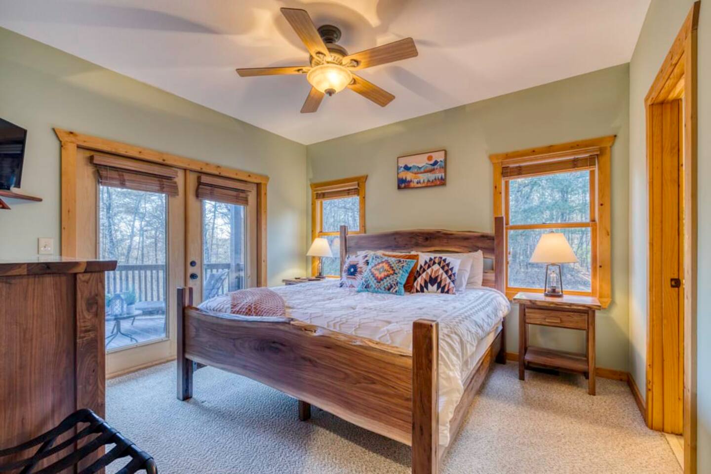 Indulge in a cozy bedroom featuring balcony access and a private ensuite bathroom.