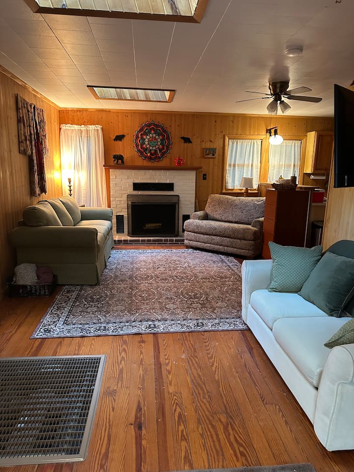 Cozy living room with two sleeper sofas — one folds into a twin bed, the other a cot-size. Perfect for extra guests! Fresh bedding is stored in the closet. Ideal for relaxing after a day exploring the orchards, trails, or lakes nearby.