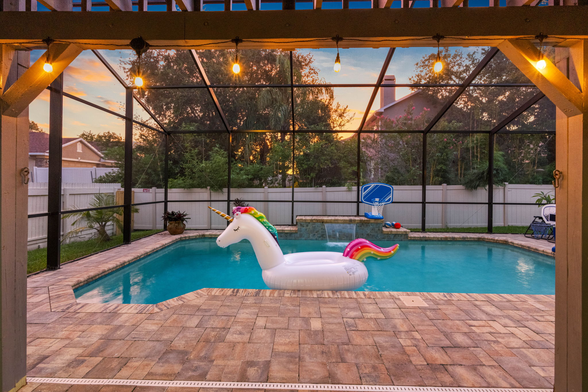 Surrounded by cozy seating, string lights, and a fully fenced yard, this pool becomes the ultimate backdrop for relaxation and celebration.