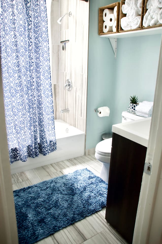 Clean bathroom with shower and fresh towels provided for your stay.