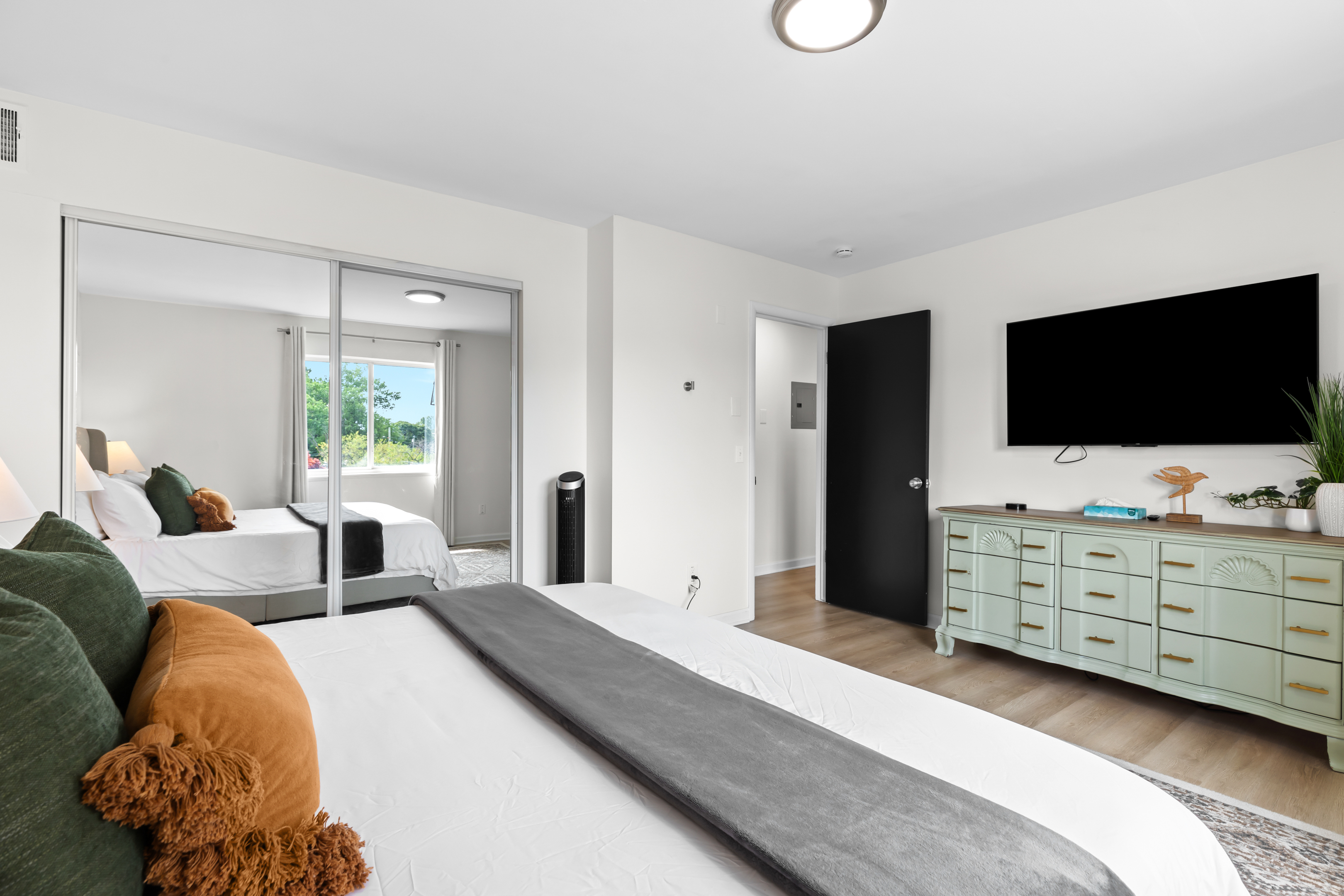 Relax in a private bedroom with a comfortable bed and wall-mounted TV.