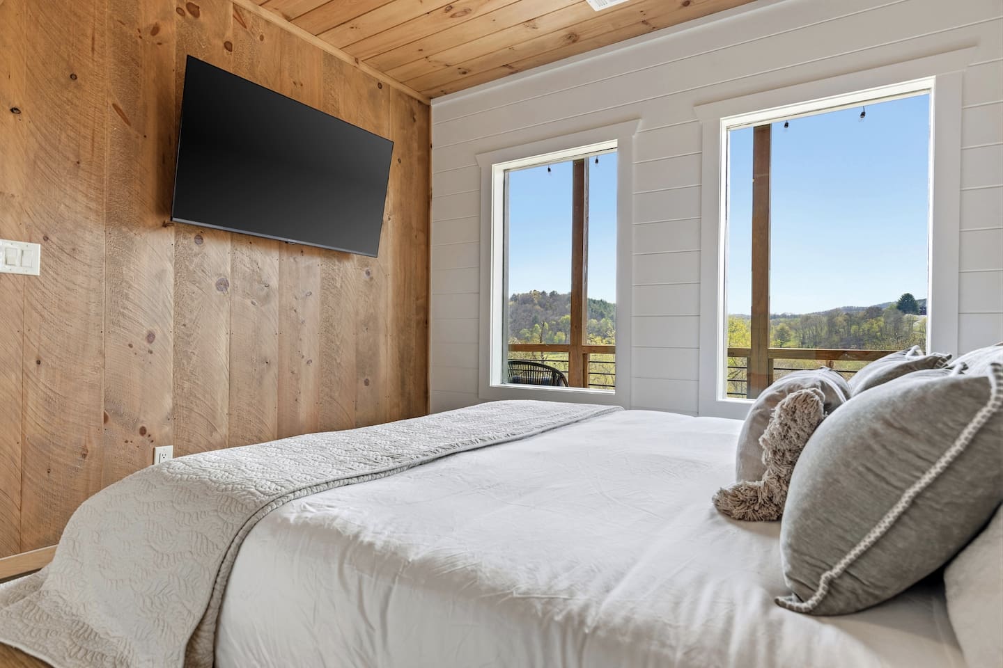 Unwind in comfort with a ceiling fan and 55” wall-mounted TV. This bedroom also includes a private closet equipped with a box fan and luggage rack — perfect for white noise and convenient unpacking after your travels.