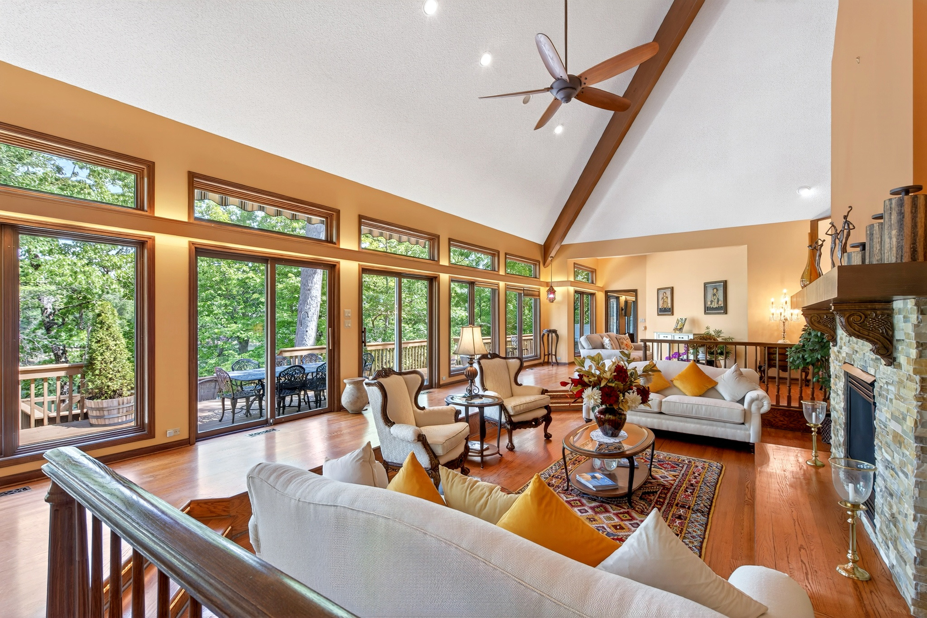 Large upper level living room with plenty of seating and natural light