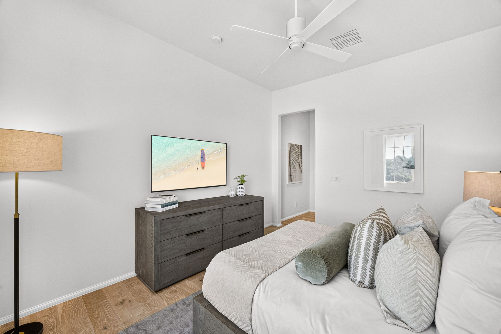 Guest Suite #2 offers a large dresser, wall-mounted Smart TV, a large closet for your clothes, and an ensuite bath with walk-in shower.