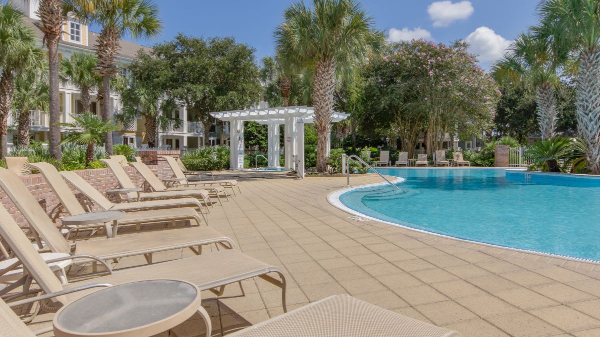 Lounge chairs along the Pilot House pool deck with the hot tub pergola beyond