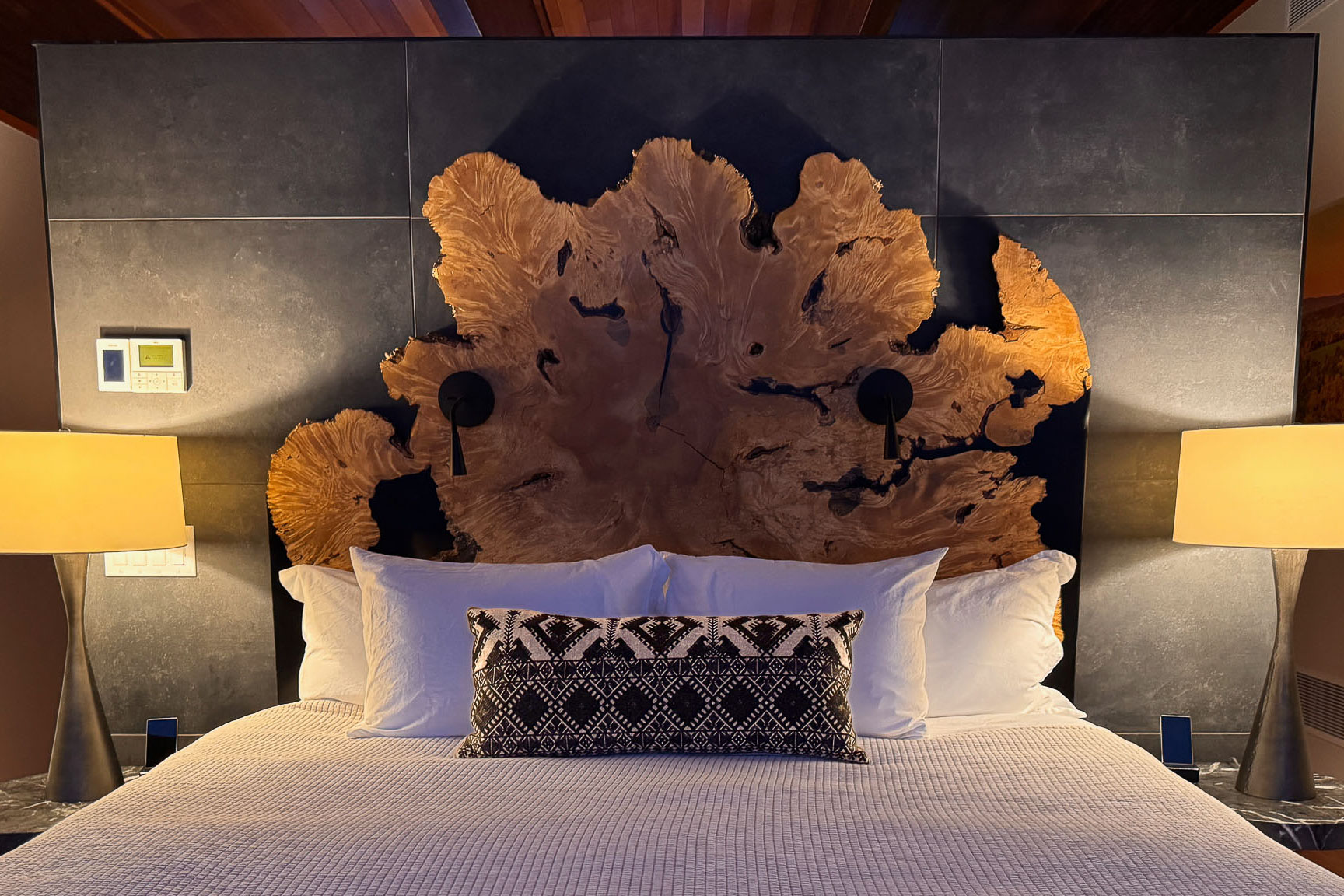 Primary Suite &mdash; king bed, burled walnut headboard, cedar plank ceiling