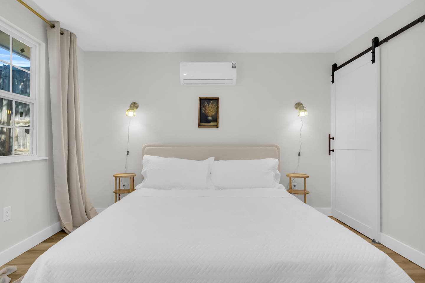 Enjoy a relaxing stay with a plush king bed, sliding barn door closet, and a fully stocked bathroom complete with a shower and Ginger Lily Farms essentials.