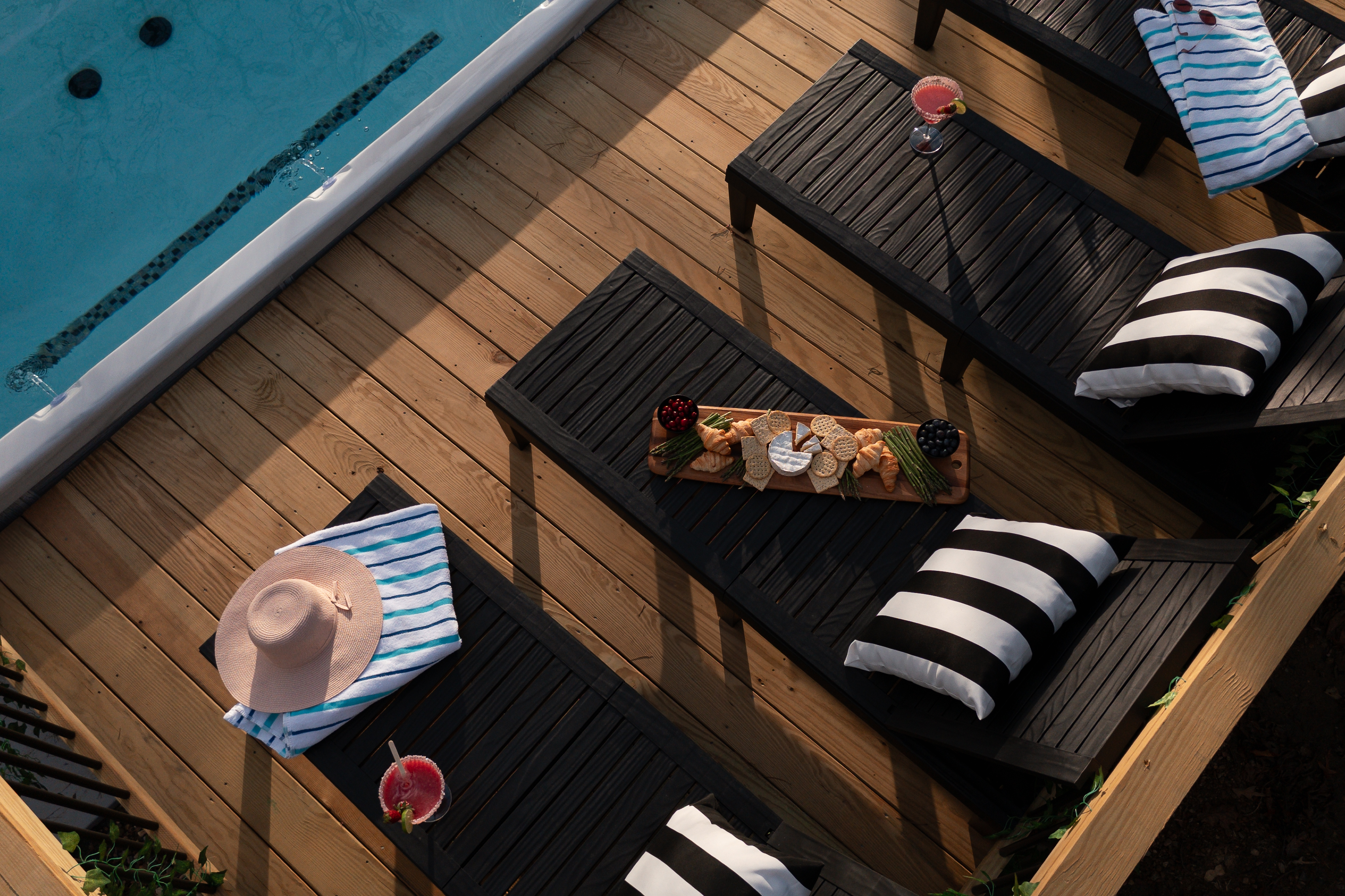 {Pool Deck - Gallery House} A perfect setup: crisp cocktails, shared bites, and warm swim spa water—not a care in the world.