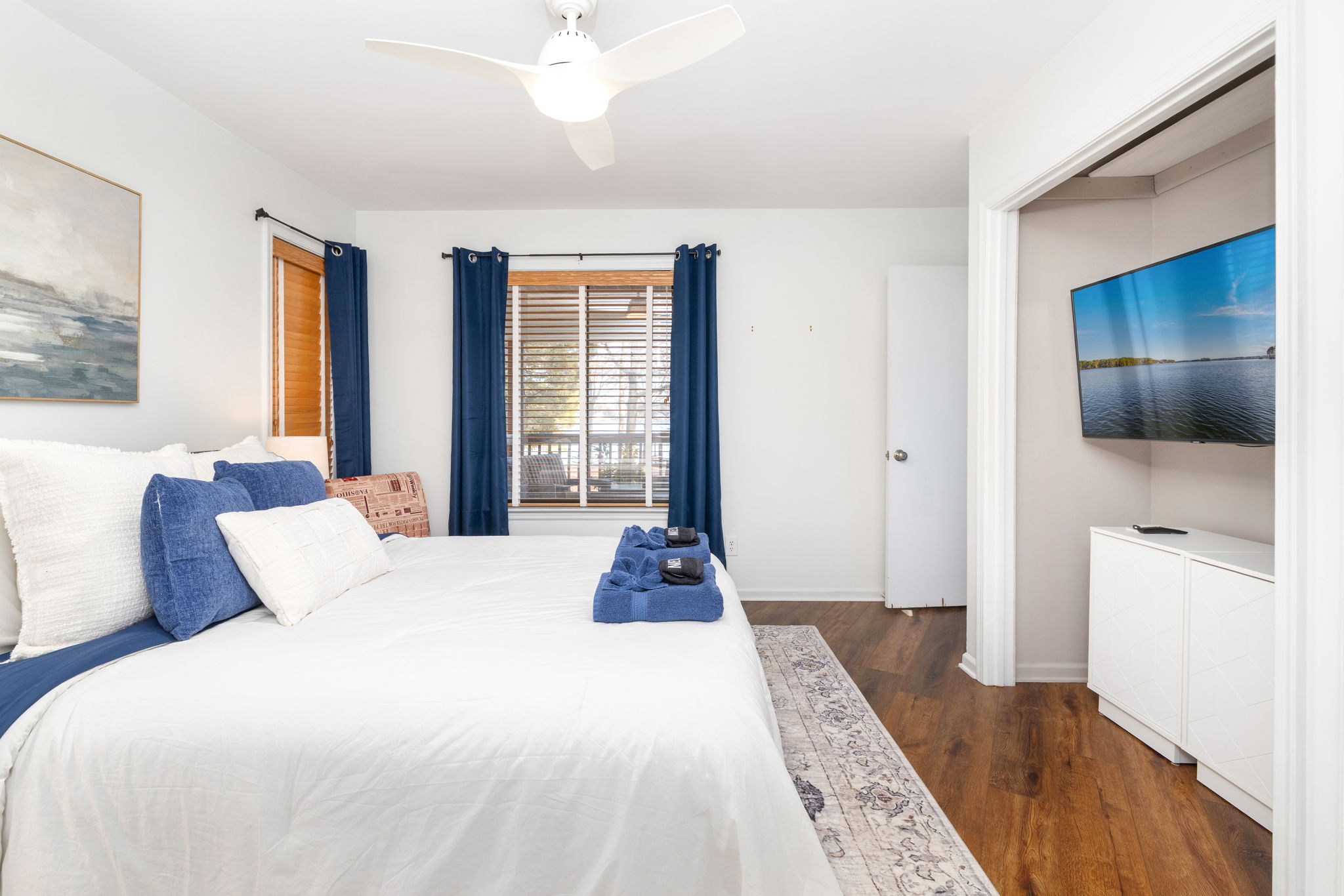 Charming Bedroom 1: Bright, airy space with plush bedding and a serene view for ultimate relaxation!