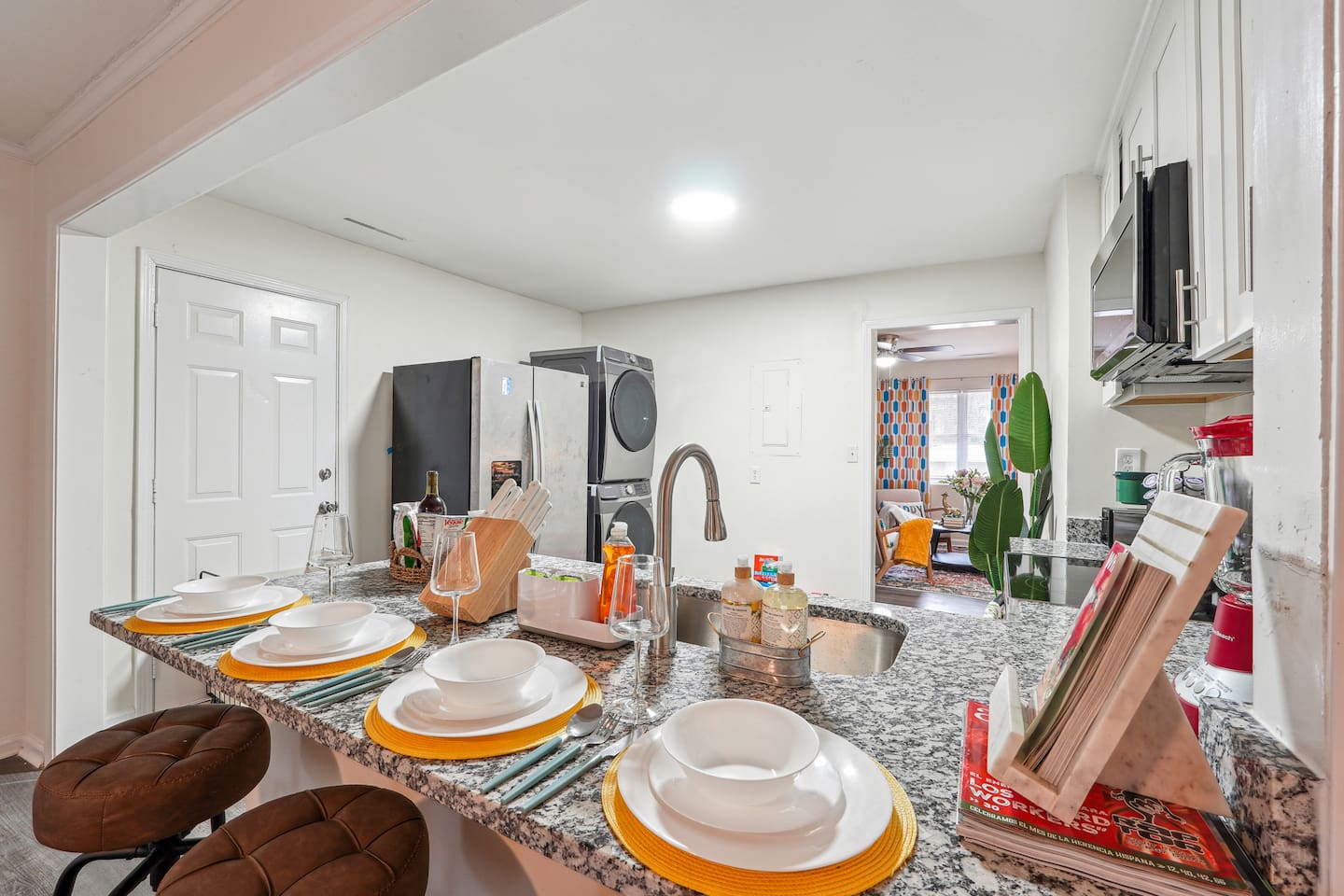 A dining area featuring a dining table set and a bar counter with four bar chairs — perfect for enjoying meals or casual drinks.
