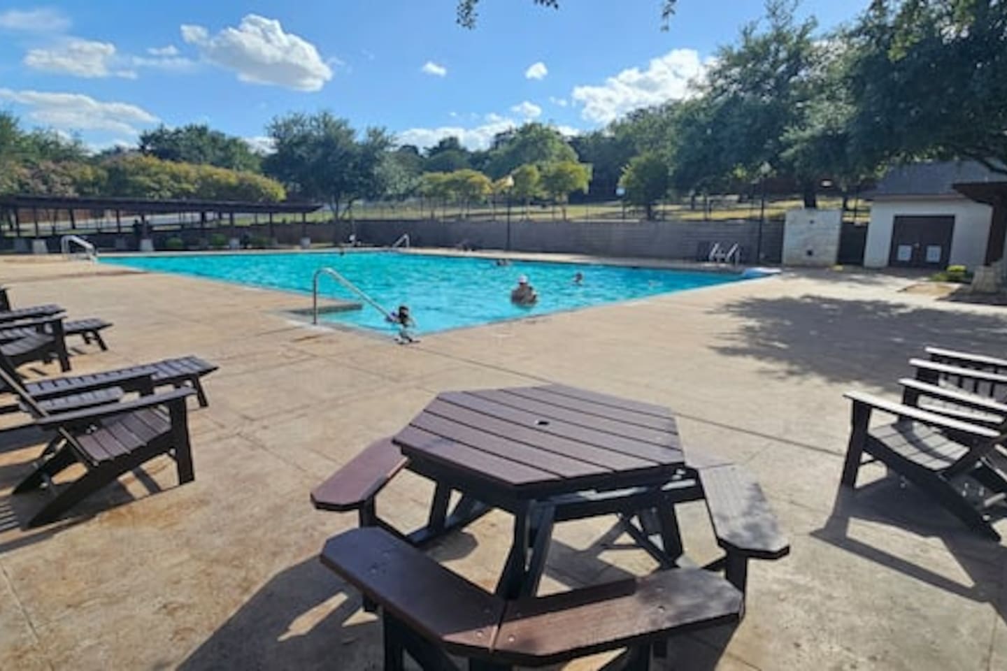 Shared neighborhood pool for guests use, offering a refreshing space to relax and unwind during your stay.