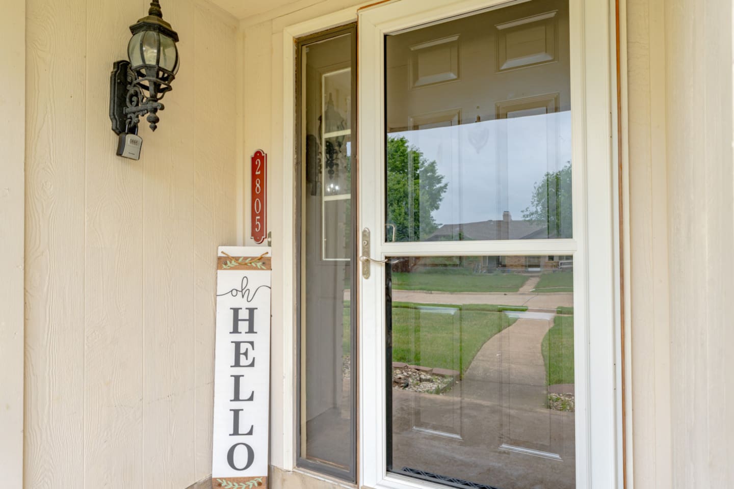 Welcoming curb appeal with manicured lawn and covered entry.