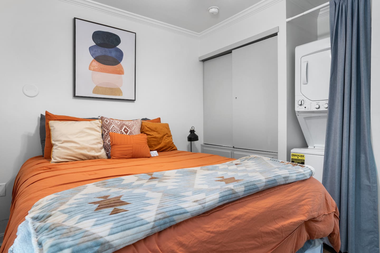 Queen size bed with closet and washer/dryer set conveniently located. 