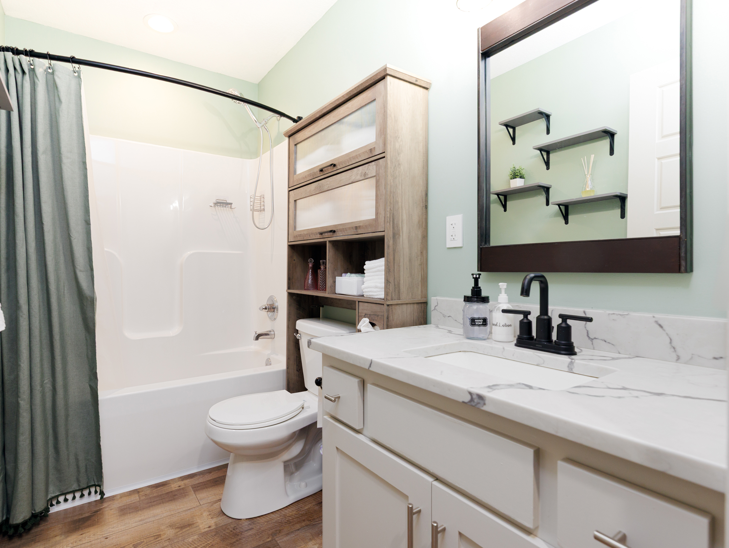 Full hall bathroom with tub/shower combination, conveniently shared by the second and third bedrooms.