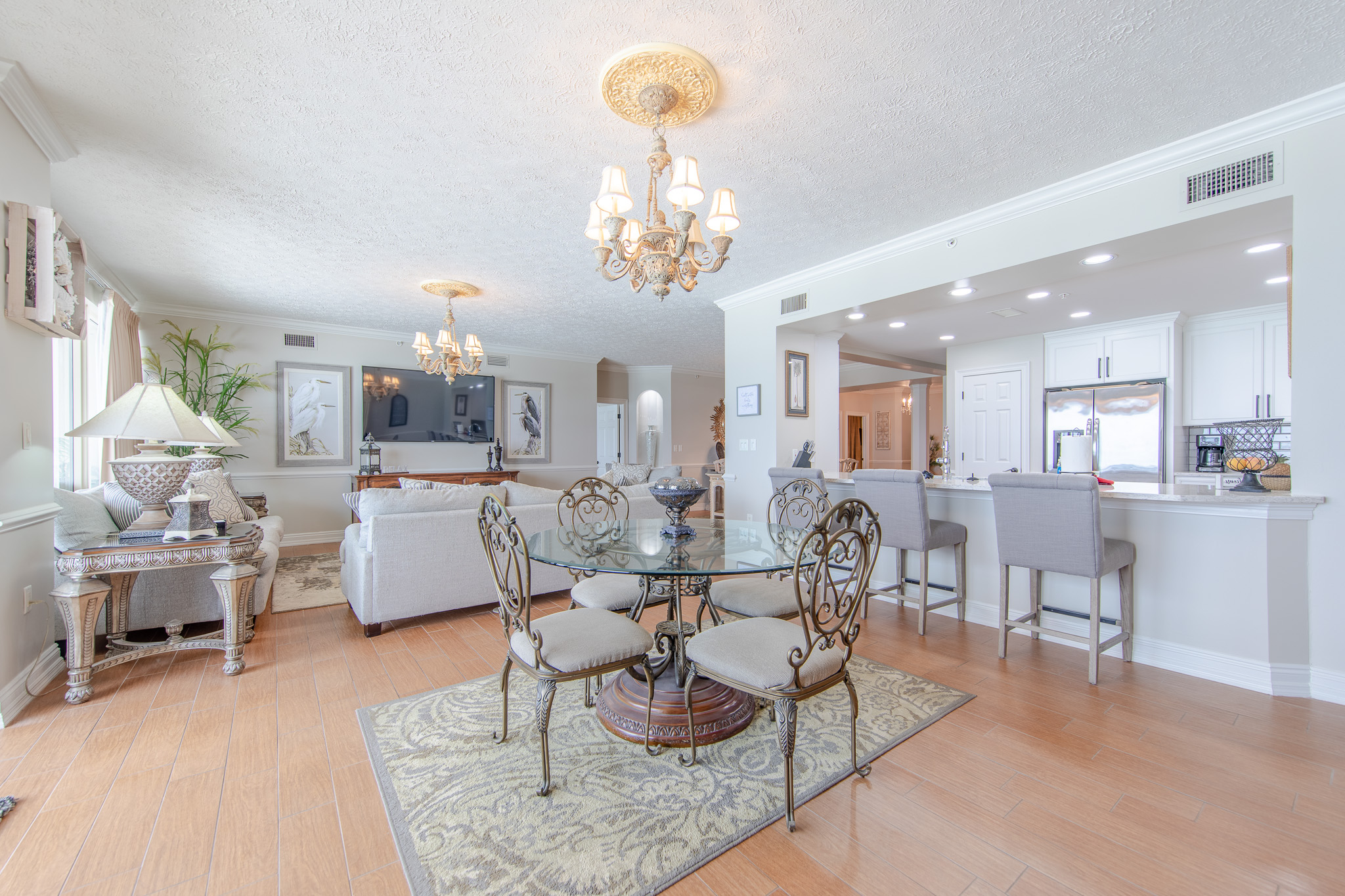 Breakfast Area Looking Into the Living Area with Commfortable Seating and a 70 Inch Smart TV