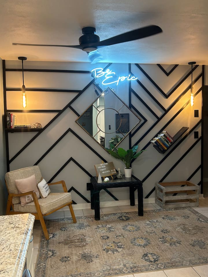 Enjoy the reflection of the bright neon sign as you pick a book off the shelf to enjoy while the nice ocean breeze blows through the open french doors, to make the inside feel more like an extension to the outside.