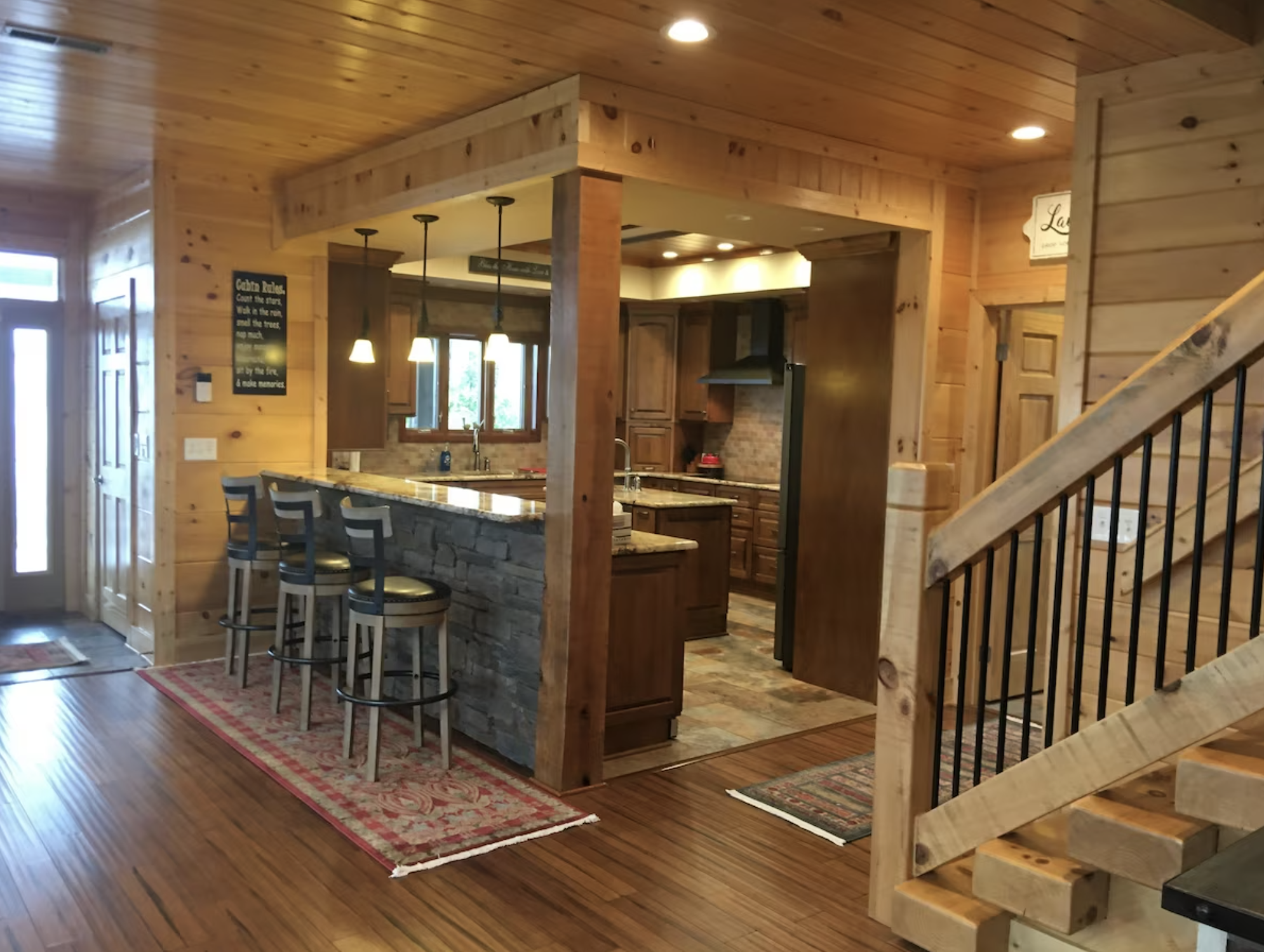 The breakfast bar overlooks the huge kitchen, fit with every pot, pan, bowl, and appliance you may need.