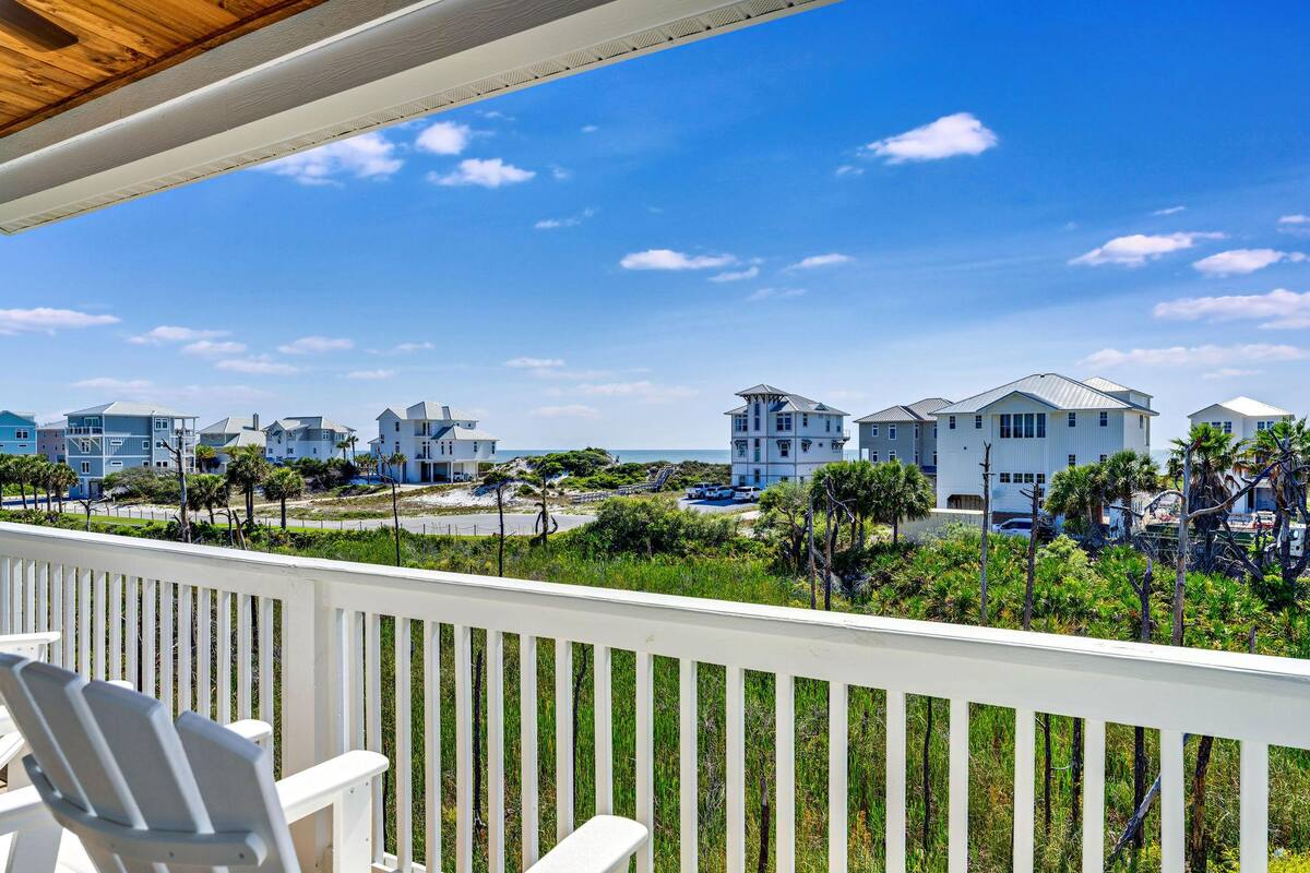 Step out from the second-floor living room onto a covered balcony with sweeping Gulf views, the perfect spot to unwind with ocean breezes and coastal charm.